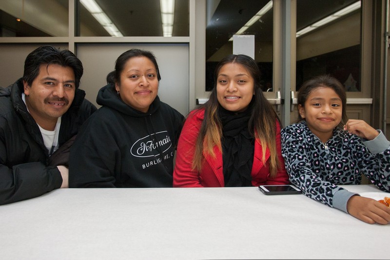 Ana Hernandez, seated second from left, is PTA chapter president at Junipero Serra Elementary in Bernal Heights, where her daughter Jasmine (far right, next to her big sister) goes to school. Hernandez emigrated from Guatemala in 2004, fleeing poverty and a society shattered by 50 years of civil war. Today, she supports the entire family working 42 hours a week as a cook in Burlingame. Her husband, Byron, lost one of his fingers in an accident on his job as a laundry mechanic, and as a result he is out of work. Despite her inflexible and demanding schedule, Hernandez said she stays involved with the PTA because it gives her life meaning and community. But for the family to make ends meet, she needs a second job. If she succeeds in finding one, she said she would have to quit leading the PTA. Photo: Luke Thomas / San Francisco Public Press