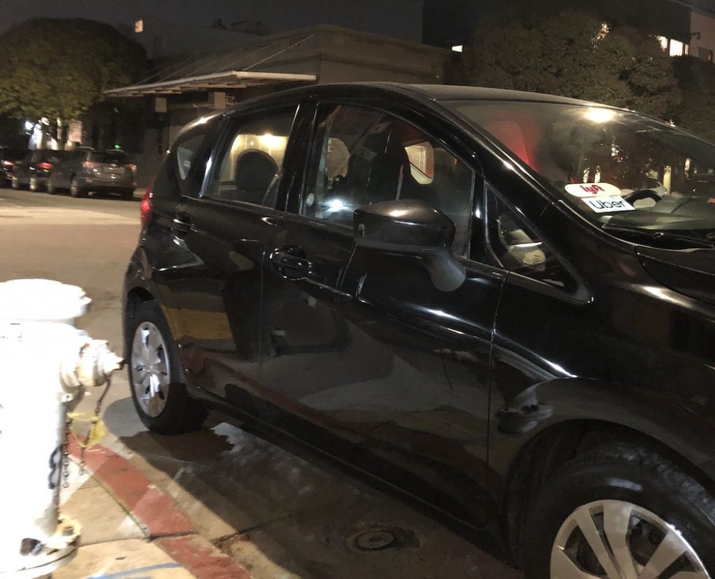 Ride-hailing drivers make many short trips and sometimes illegal stops. In early January, a driver checked his app for new customers while parked in front of a fire hydrant in the Mission District. Photo by Michael Stoll // Public Press