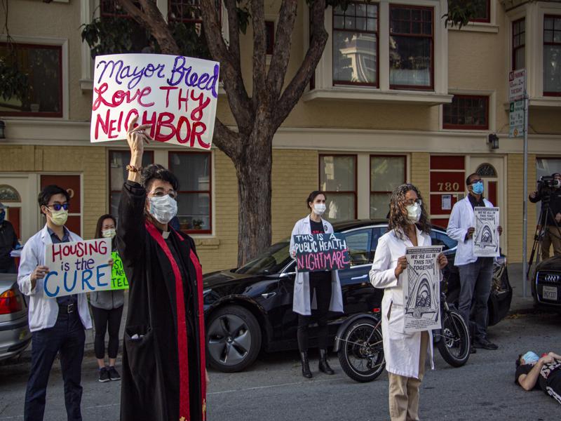 reverend_monique_ortiz_holds_sign_4.30.20-800x600.jpg