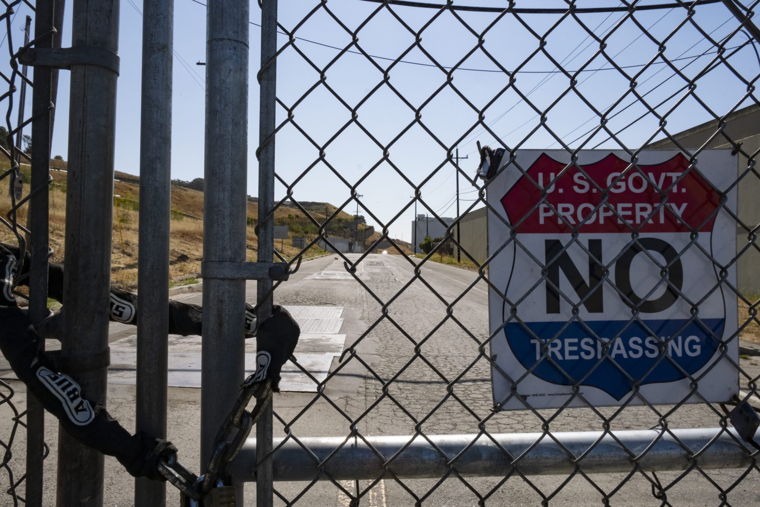 A gate with a chain lock, with a sign saying U.S. Government Property, No Trespassing